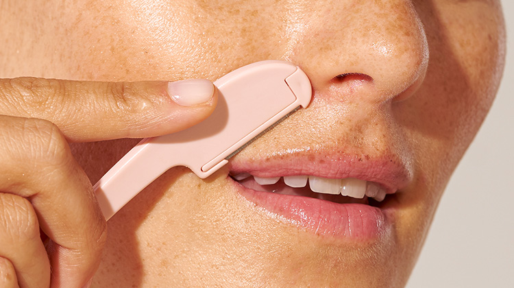 model holding prep and plane facial razor to upper lip area